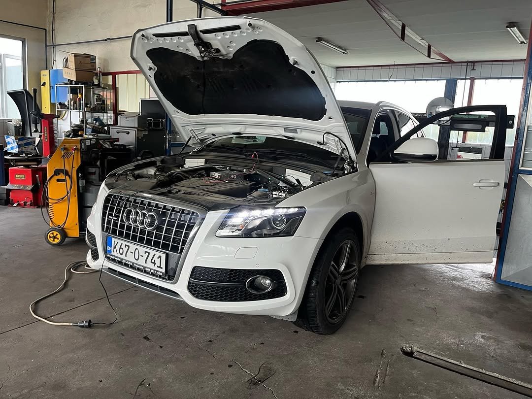 Audi Q5 on a road with AdBlue warning message on dashboard