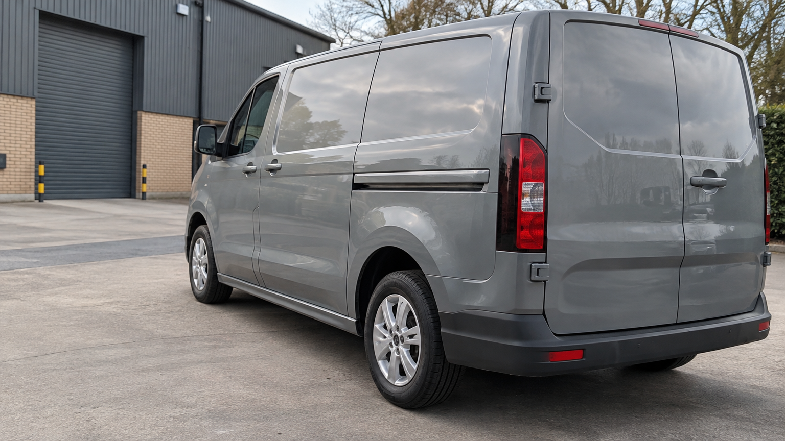 Illustrative photograph of a modern diesel van parked in a UK business yard in daylight.